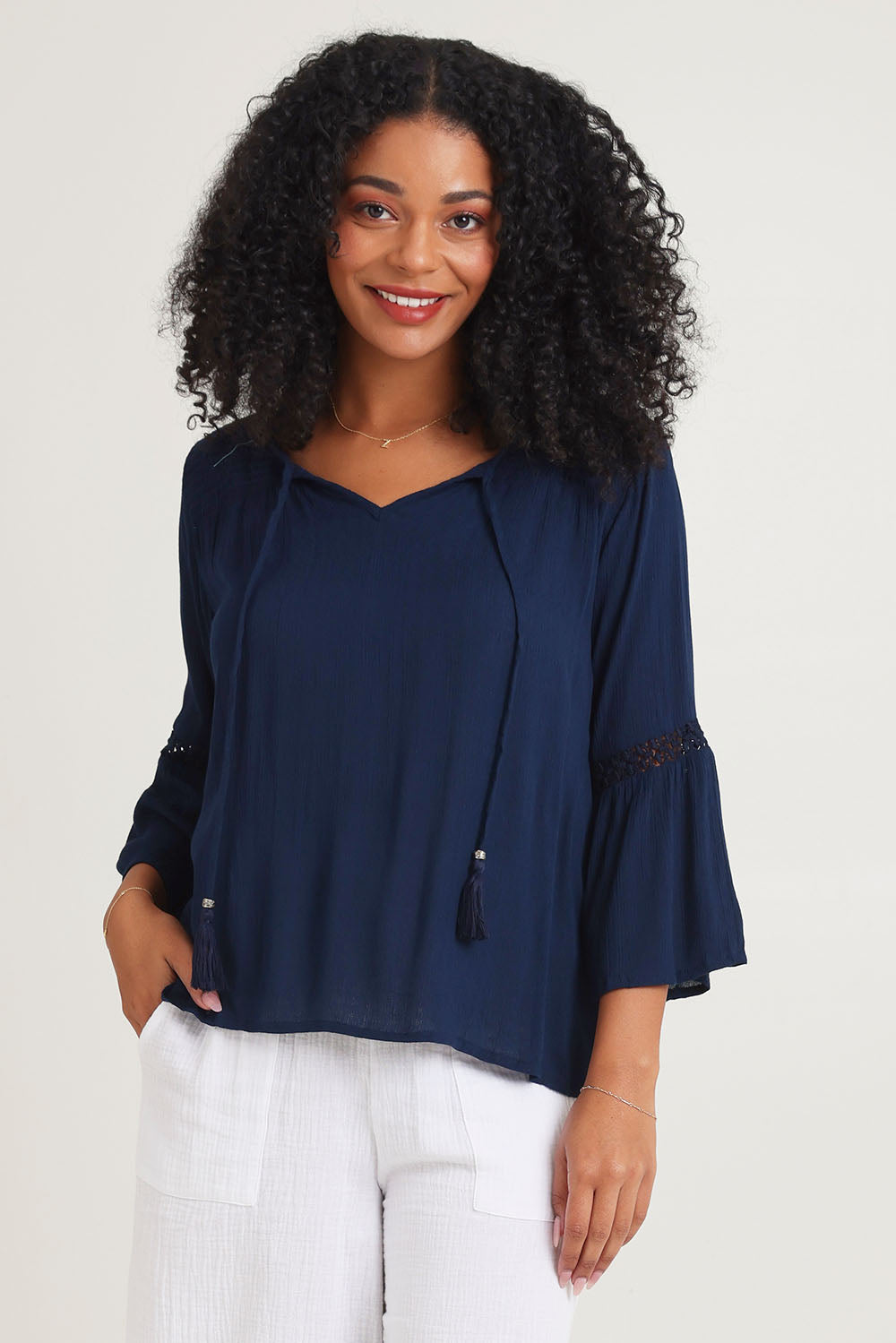 Model Ziara wearing size 10 of the Boho Top in colour Navy (Blue), from the front, cropped image