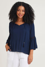 Model Ziara wearing size 10 of the Boho Top in colour Navy (Blue), from the front, cropped image