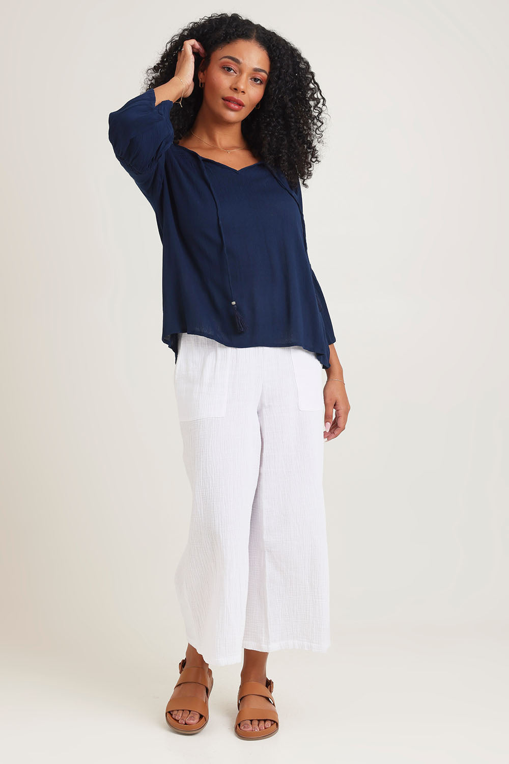 Model Ziara wearing size 10 of the Boho Top in colour Navy (Blue), from the front, showing the whole outfit