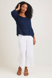 Model Ziara wearing size 10 of the Boho Top in colour Navy (Blue), from the front, showing the whole outfit