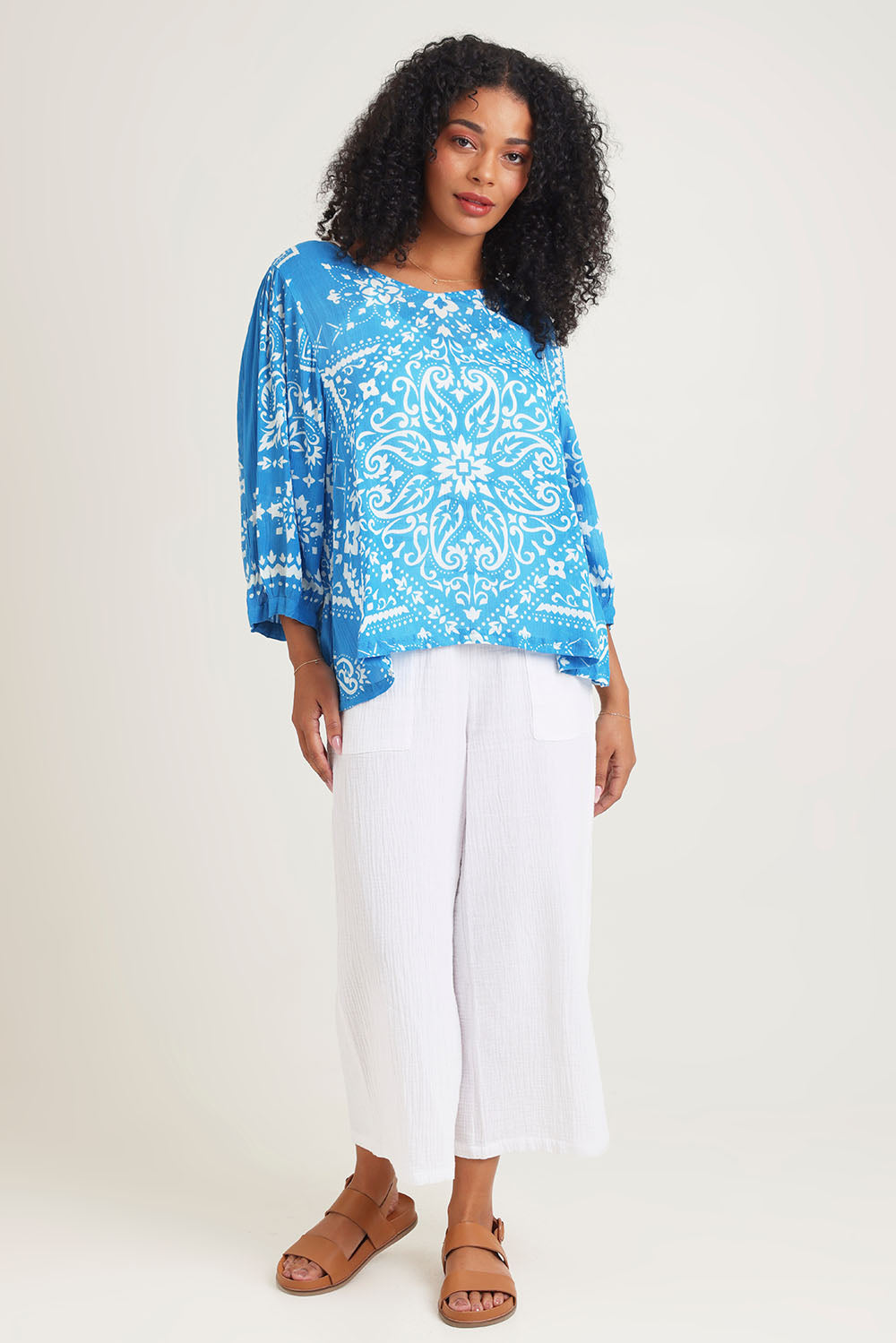 Model Ziara wearing size 10 of the Boho Blouse in colour Bandanabl (Blue), from the front, showing the whole outfit