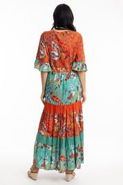 A model wearing the Serengetti V Neckline Dress in colour Red (Green), from the back