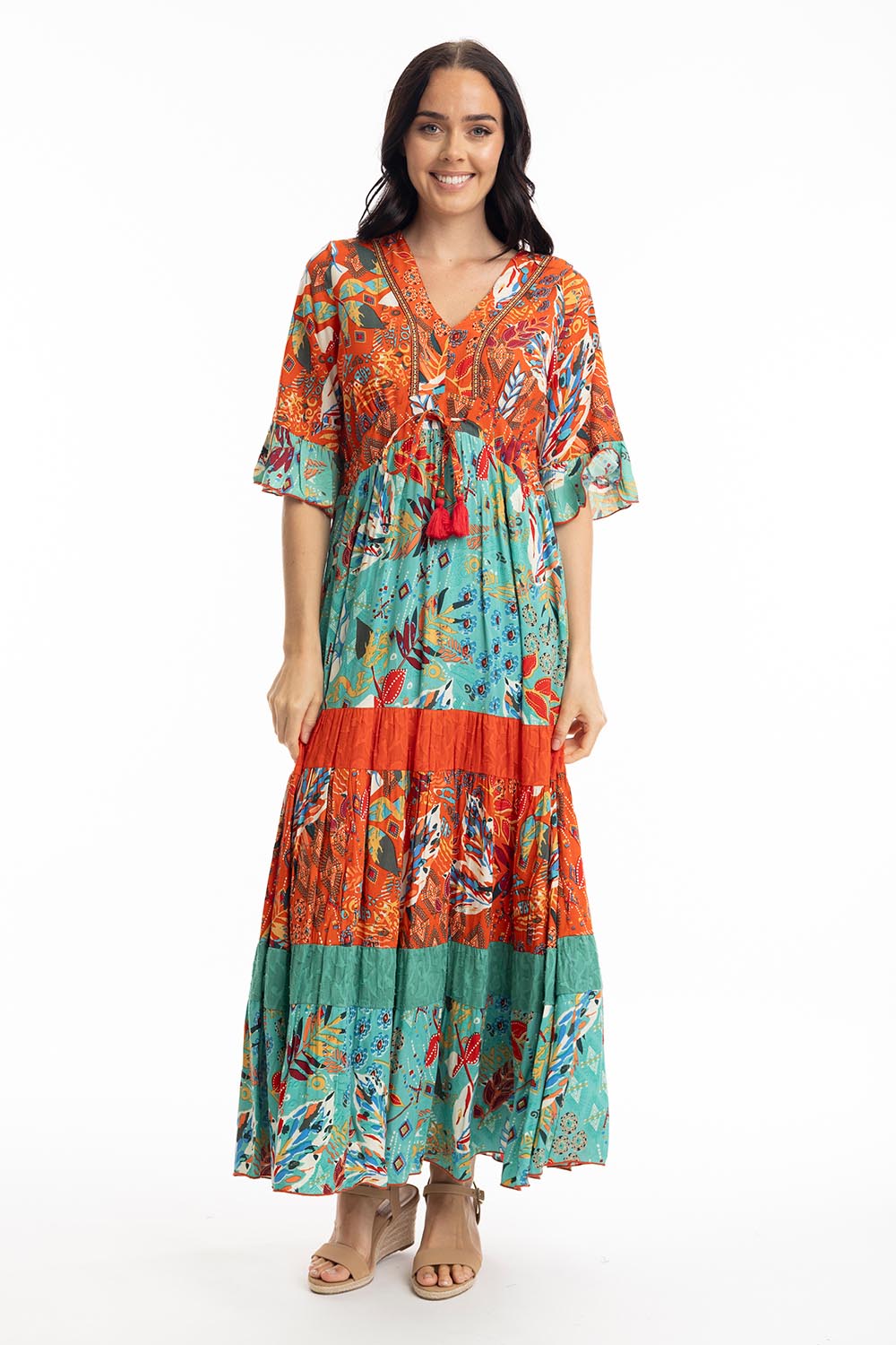 A model wearing the Serengetti V Neckline Dress in colour Red (Green), from the front, showing the whole outfit