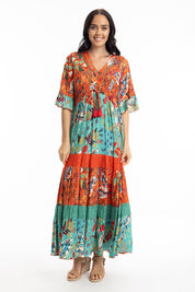 A model wearing the Serengetti V Neckline Dress in colour Red (Green), from the front, showing the whole outfit