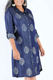 Model Nadine wearing size 10 of the Denim Leaf Print Dress in colour Denim (Blue), from the front, cropped image