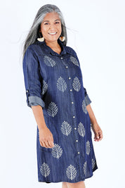 Model Nadine wearing size 10 of the Denim Leaf Print Dress in colour Denim (Blue), from the front, cropped image