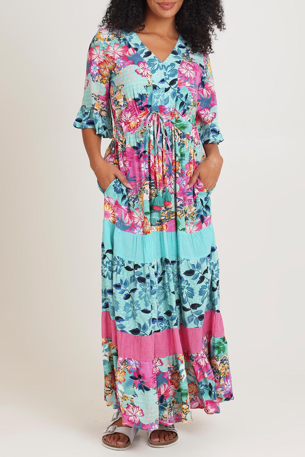 Model Ziara wearing size 10 of the Vin colourNeckline Layers Maxi Dress - Selaron, from the front, cropped image