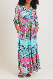 Model Ziara wearing size 10 of the Vin colourNeckline Layers Maxi Dress - Selaron, from the front, cropped image