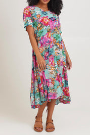 Model Ziara wearing size 10 of the Short Sleeve Godet Dress in colour Selaron, from the front, cropped image