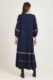 Model Madeline wearing size 10 of the Embroidered Maxi Dress in colour Ivanova (Blue), from the back