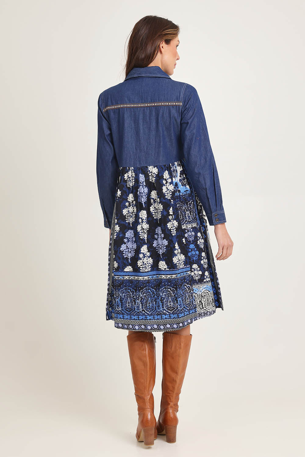 Model Madeline wearing size 10 of the Denim Mix Dress in colour Bhadoi (Blue), from the back