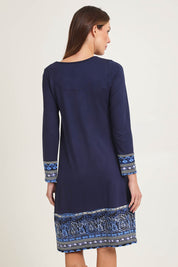 Model Madeline wearing size 10 of the Solid Body Patch Dress in colour Bhadoi (Blue), from the back
