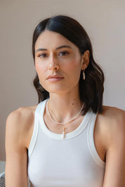 A model wearing the Lunar Pearl Drop Hoop Earrings in colour Goldpearl (Metallics), from the front, showing the whole outfit