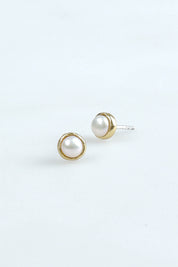 A model wearing the Lunar Pearl Stud Earrings in colour Pearlstud (Metallics), from the front, showing the whole outfit