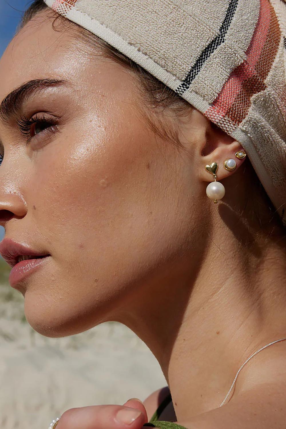 A model wearing the Lunar Pearl Stud Earrings in colour Pearlstud (Metallics), from the front, showing the whole outfit