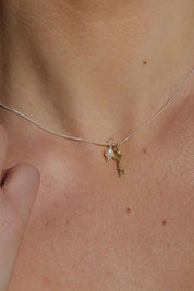 A model wearing the Dreamweaver Necklace in colour Potential (Metallics), from the front, showing the whole outfit