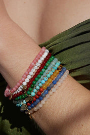 A model wearing the Healing Gem Bracelet in colour Calmness (Blue), from the front, showing the whole outfit