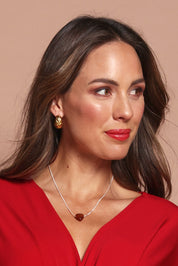 A model wearing the Heartstone Adjustable Stirling Silver Necklace in colour Energy (Red), from the front, showing the whole outfit