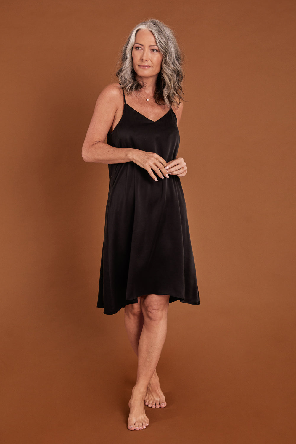Model Emma wearing size S of the Audrey Silk Slip Nightie in colour Black (Black), from the front, showing the whole outfit