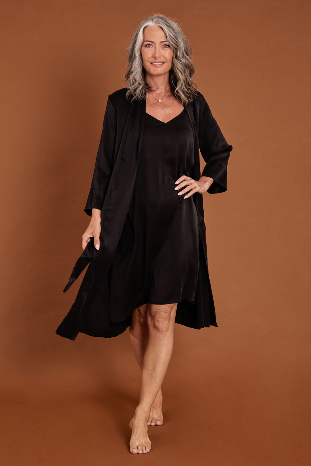 Model Emma wearing size S of the Audrey Silk Long Robe in colour Black (Black), from the front, showing the whole outfit
