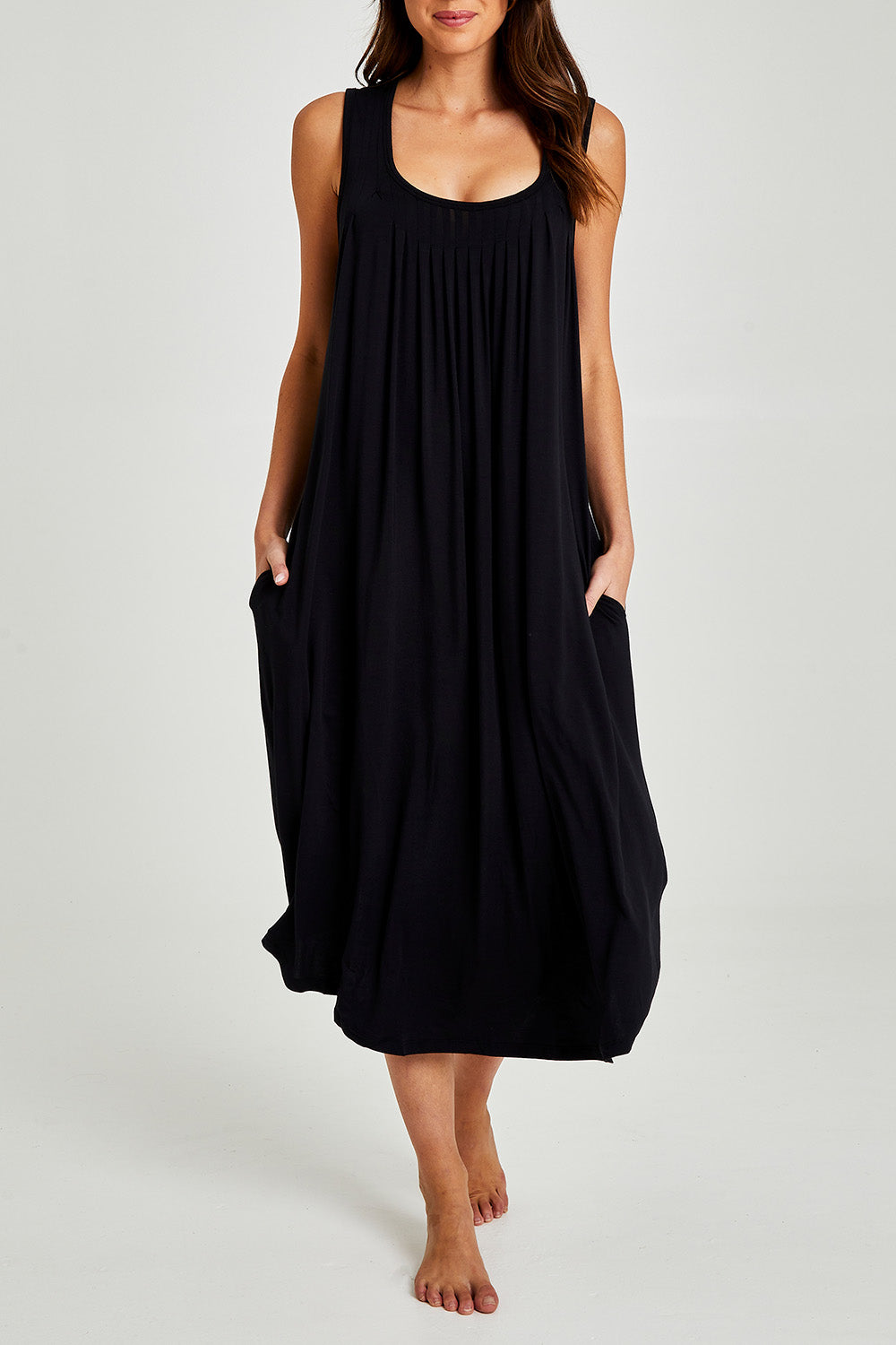 Model Madeline wearing size S of the Kate Modal Soft Pleat Front Maxi Nightie in colour Black (Black), from the front, cropped image