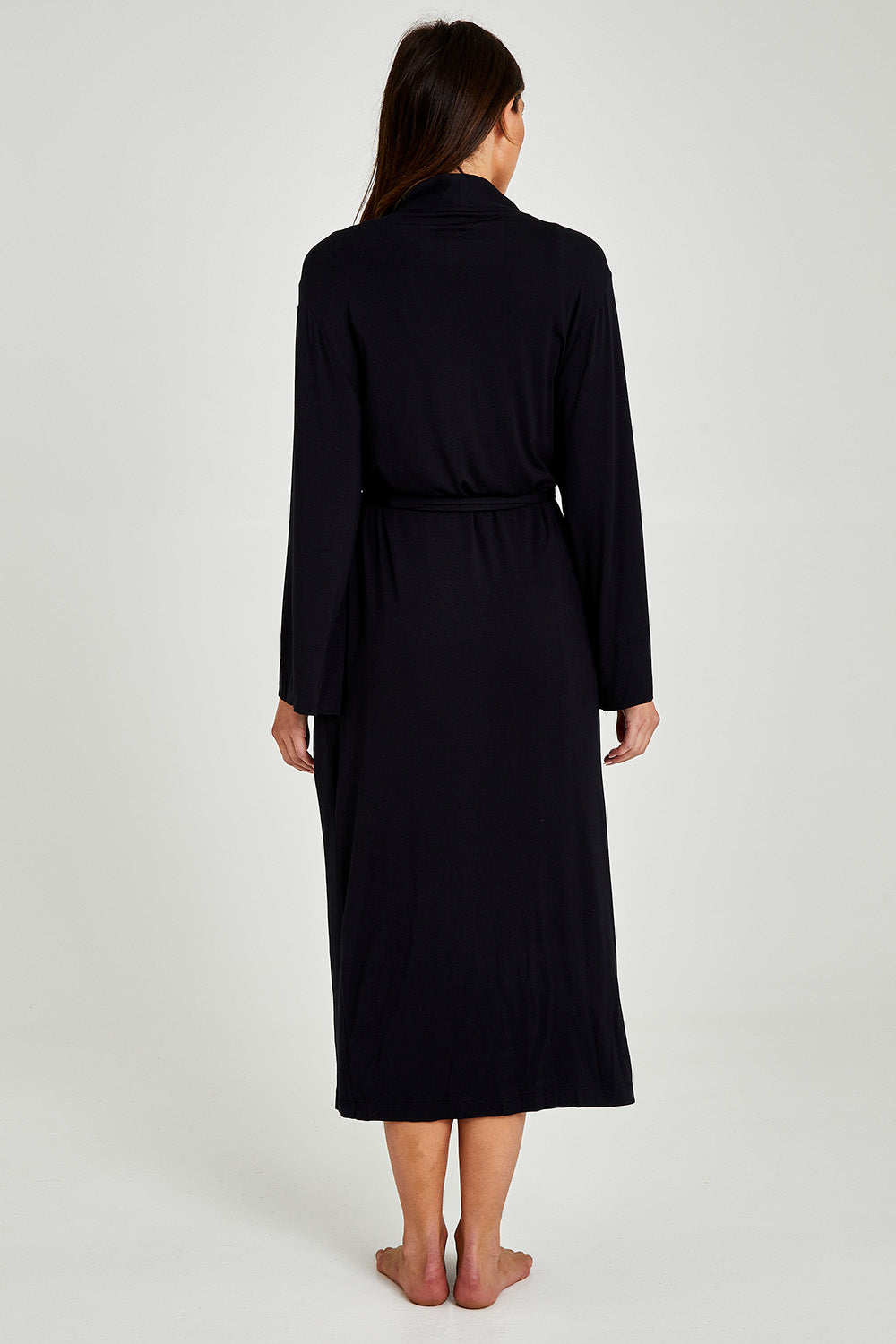Model Madeline wearing size S of the Kate Modal Soft Maxi Robe in colour Black (Black), from the back