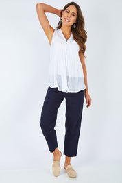 Model Madeline wearing size S of the Cotton Crinkle Swing Top in colour White (White), from the front, showing the whole outfit