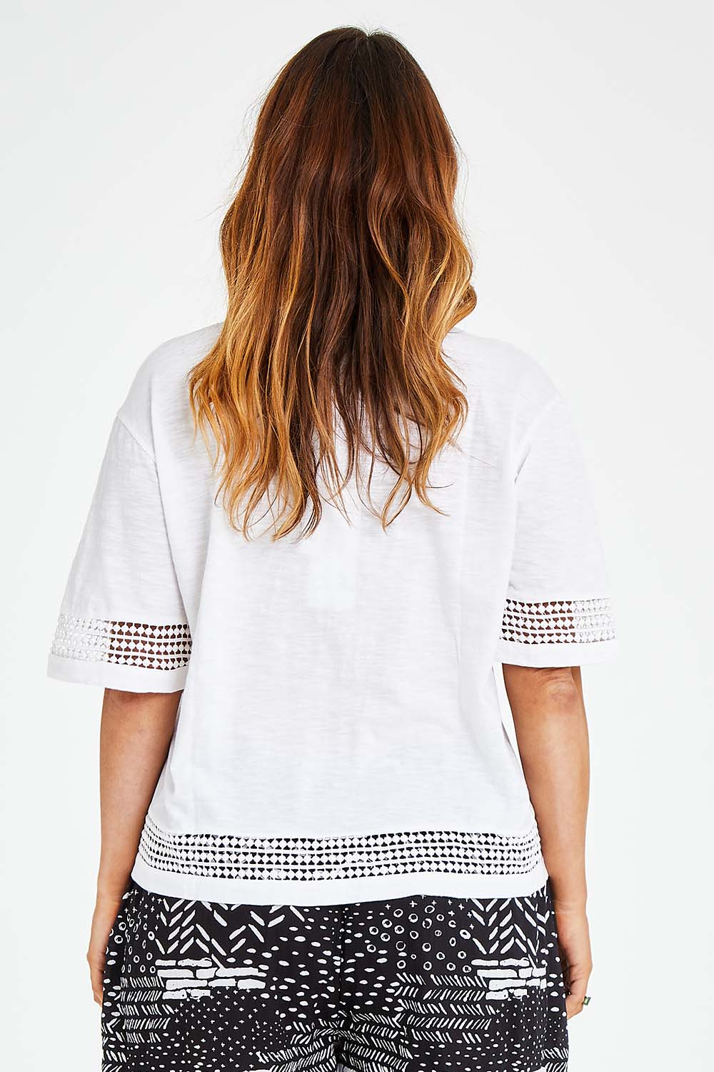 Model Laura wearing size L of the Cotton Jersey Circle Trim Box Top in colour White (White), from the back
