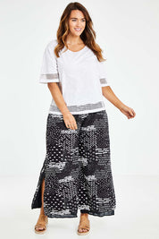 Model Laura wearing size L of the Cotton Jersey Circle Trim Box Top in colour White (White), from the front, showing the whole outfit