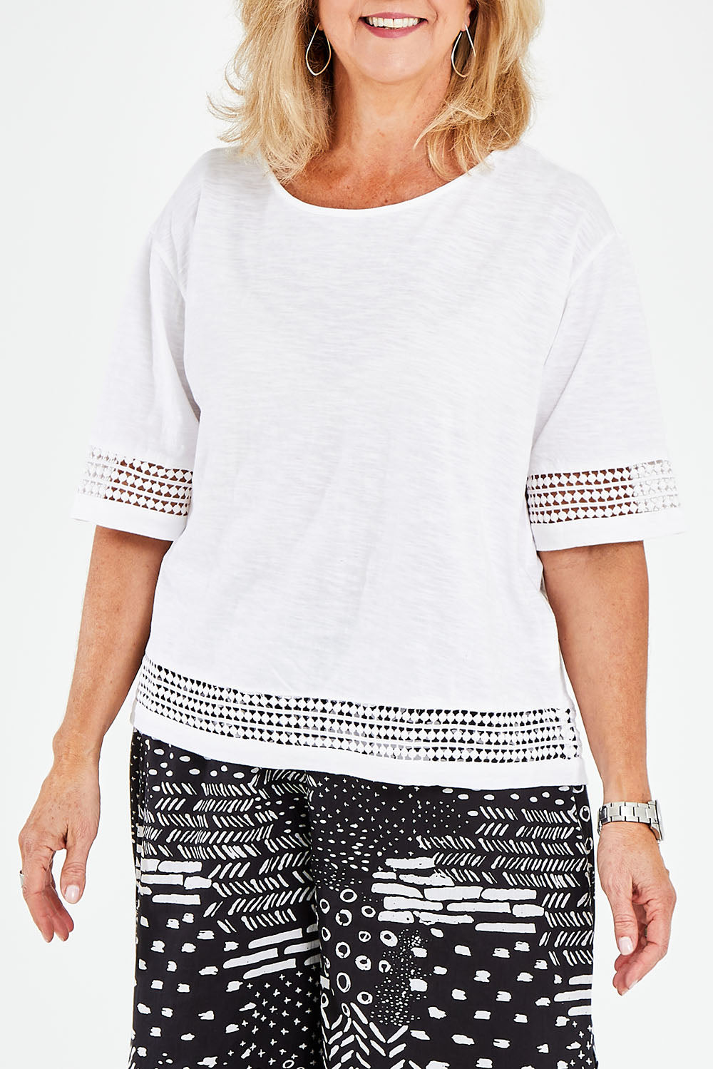 Model Sandy wearing size M of the Cotton Jersey Circle Trim Box Top in colour White (White), from the front, cropped image