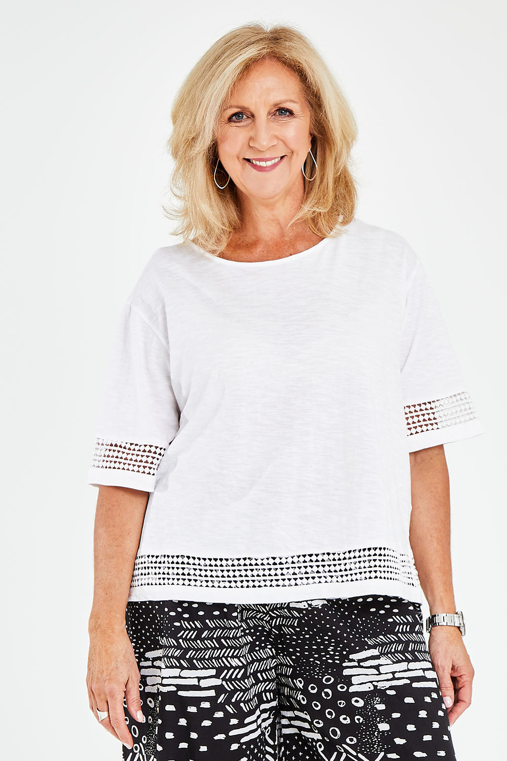 Model Sandy wearing size M of the Cotton Jersey Circle Trim Box Top in colour White (White), from the front, cropped image