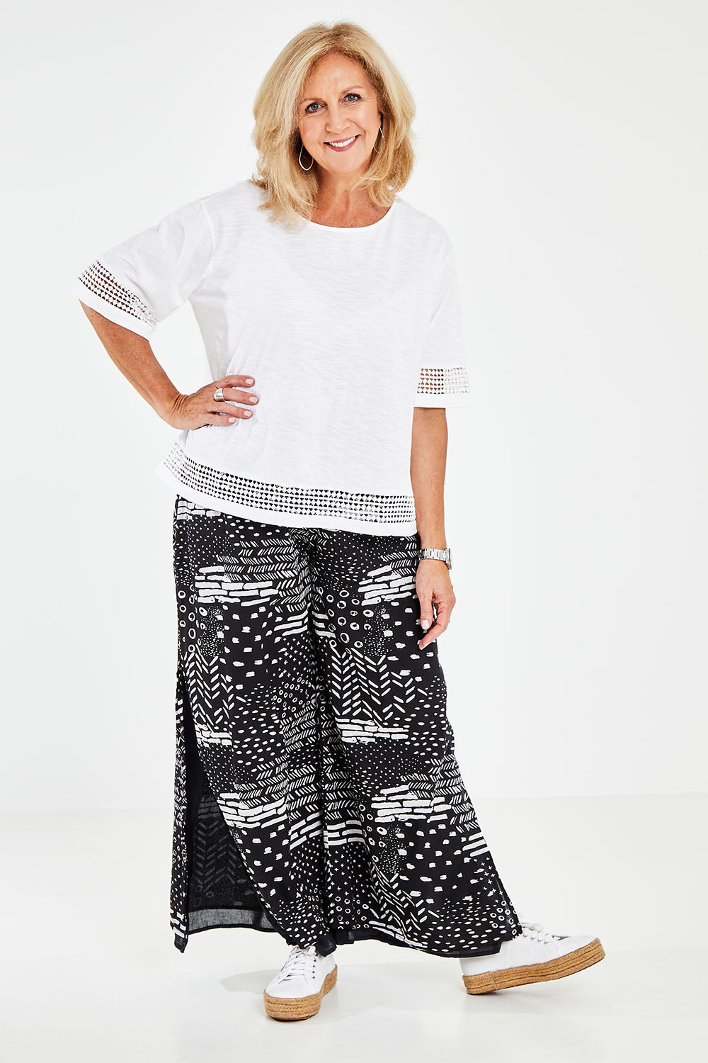 Model Sandy wearing size M of the Cotton Jersey Circle Trim Box Top in colour White (White), from the front, showing the whole outfit