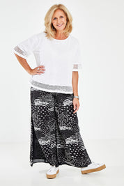 Model Sandy wearing size M of the Cotton Jersey Circle Trim Box Top in colour White (White), from the front, showing the whole outfit