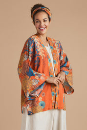 A model wearing the Kimono Jacket in colour Terracotta, from the front, cropped image