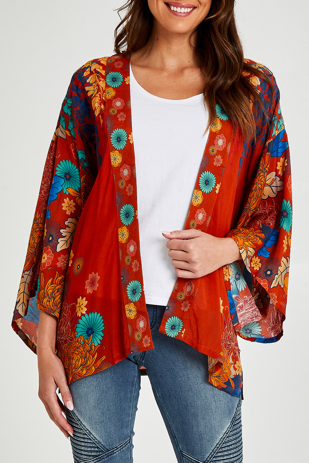Model Madeline wearing size OneSize of the Kimono Jacket in colour Terracotta, from the front, cropped image