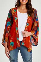 Model Madeline wearing size OneSize of the Kimono Jacket in colour Terracotta, from the front, cropped image