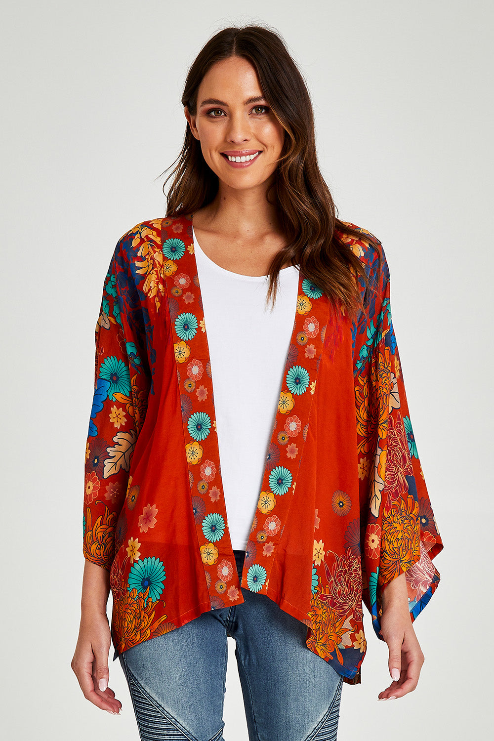 Model Madeline wearing size OneSize of the Kimono Jacket in colour Terracotta, from the front, cropped image