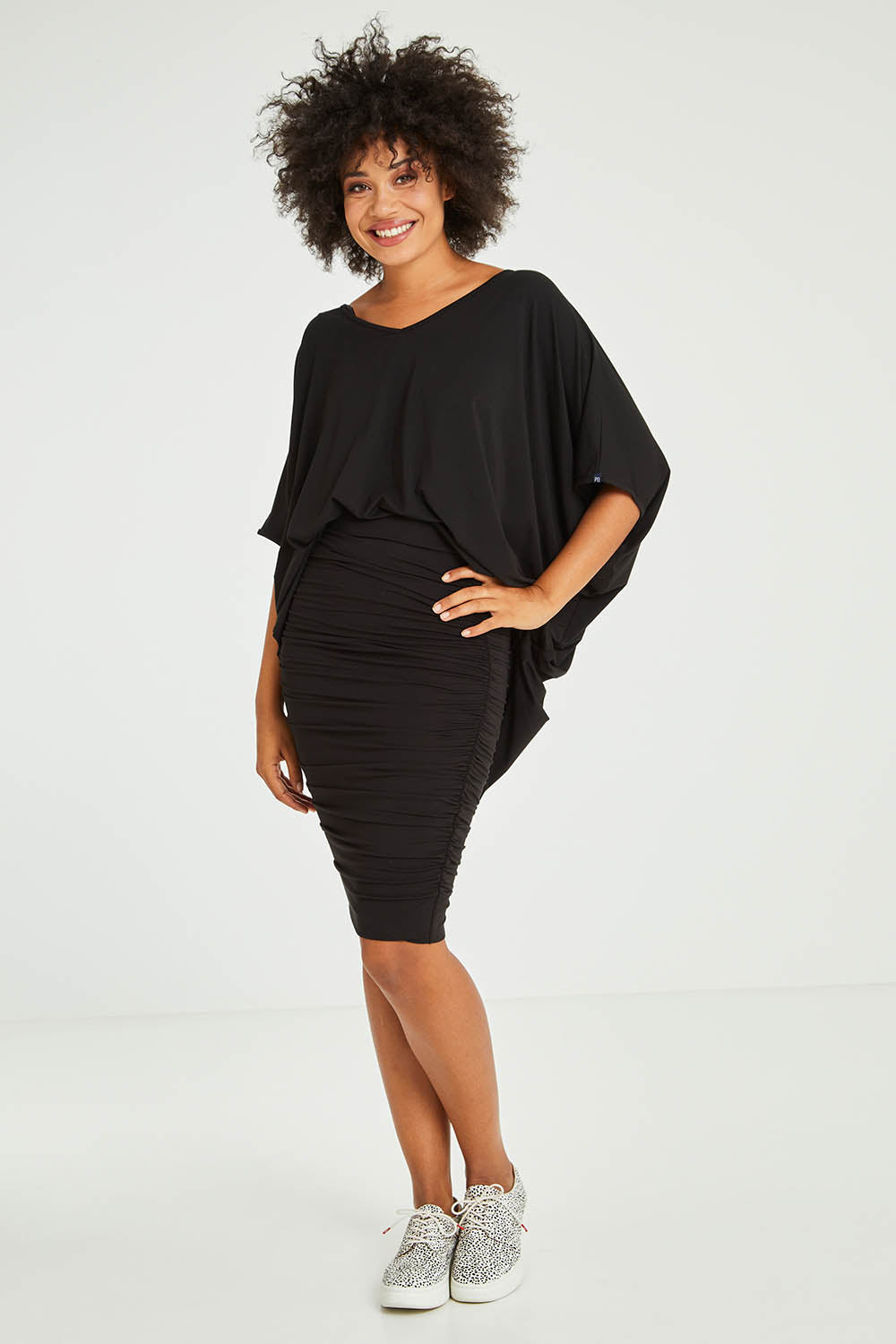 Model Olivia wearing size S of the Ruche Skirt in colour Black (Black), from the front, showing the whole outfit