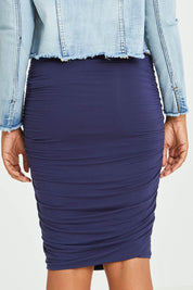 Model Olivia wearing size S of the Ruche Skirt in colour Navy (Blue), from the back