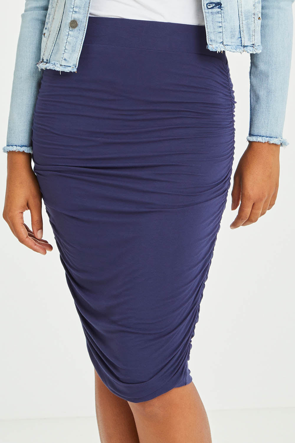Model Olivia wearing size S of the Ruche Skirt in colour Navy (Blue), from the front, cropped image