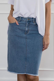 A model wearing the Frayed Denim Skirt in colour Blue (Blue), from the front, cropped image