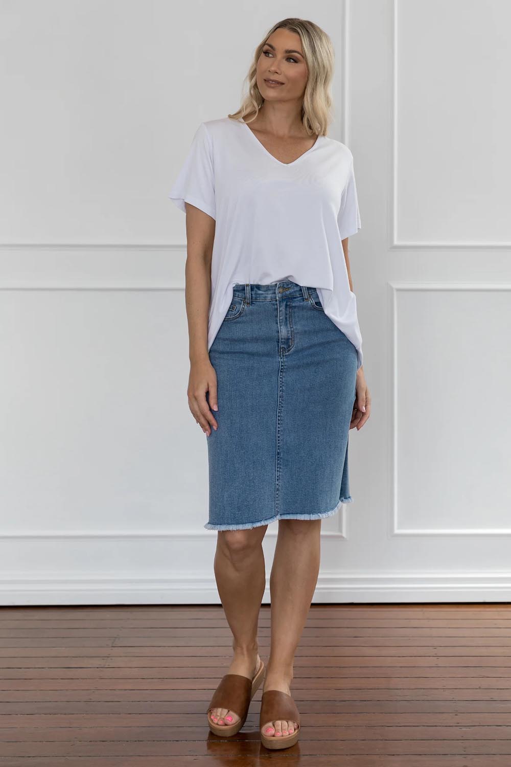 A model wearing the Frayed Denim Skirt in colour Blue (Blue), from the front, showing the whole outfit