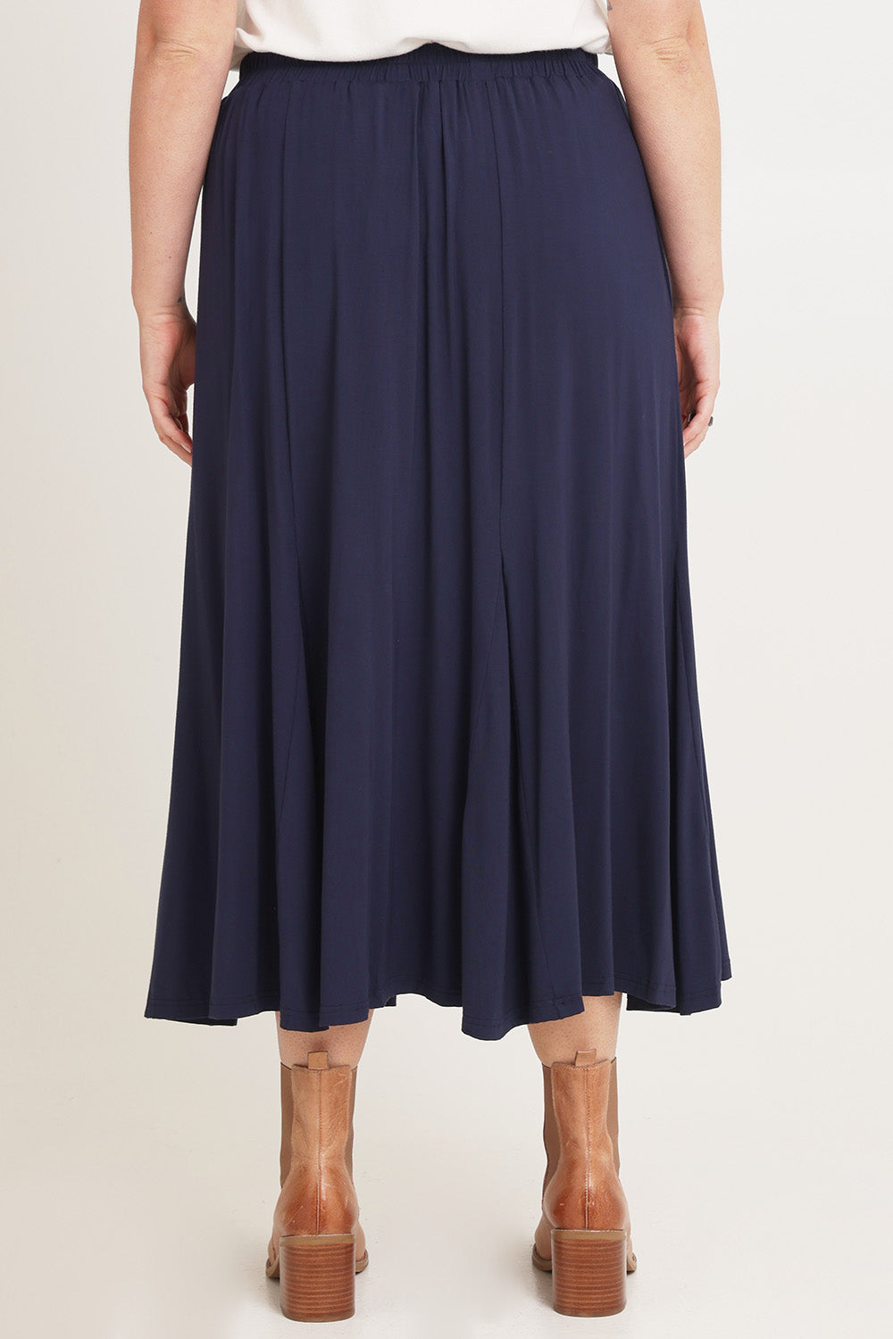 Model Chanel wearing size XL of the Adeline Bamboo Skirt in colour Navy (Blue), from the back