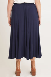 Model Chanel wearing size XL of the Adeline Bamboo Skirt in colour Navy (Blue), from the back