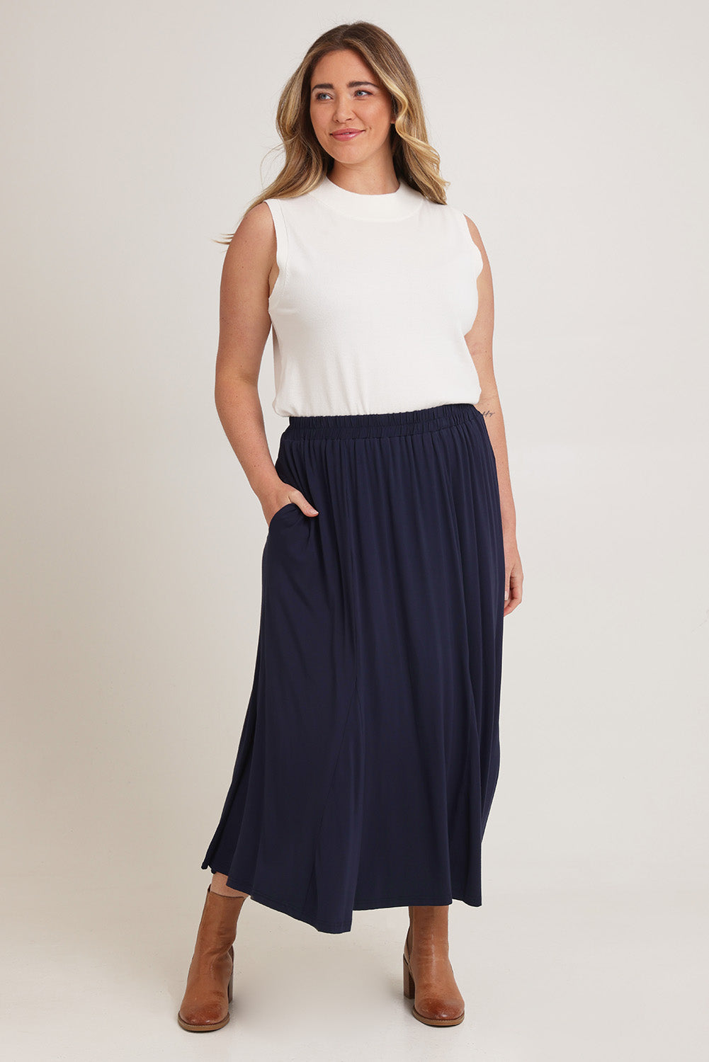 Model Chanel wearing size XL of the Adeline Bamboo Skirt in colour Navy (Blue), from the front, showing the whole outfit