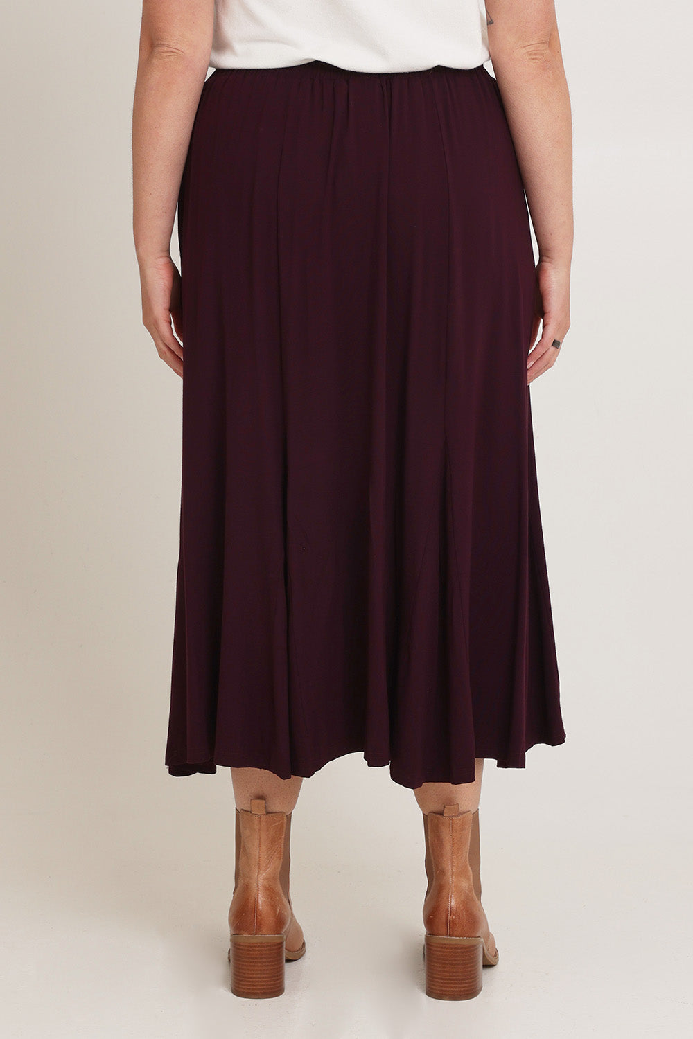 Model Chanel wearing size XL of the Adeline Bamboo Skirt in colour Shiraz (Purple), from the back