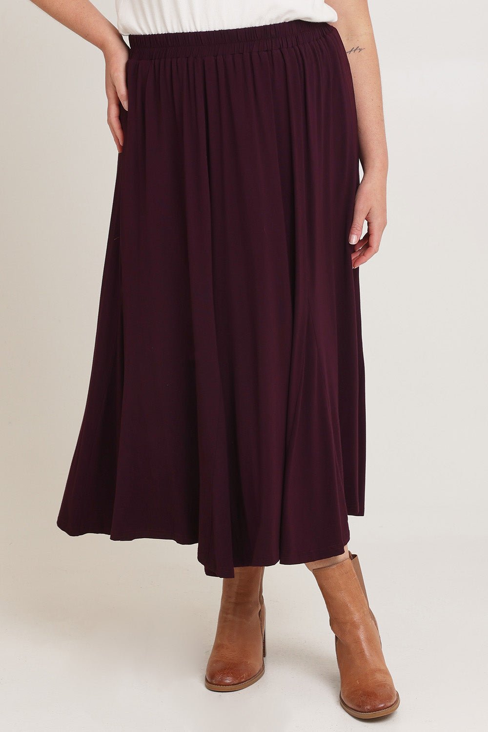 Model Chanel wearing size XL of the Adeline Bamboo Skirt in colour Shiraz (Purple), from the front, cropped image