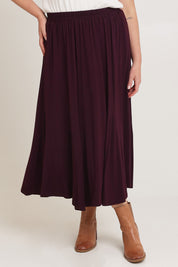 Model Chanel wearing size XL of the Adeline Bamboo Skirt in colour Shiraz (Purple), from the front, cropped image