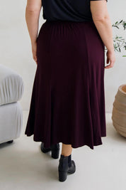 A model wearing the Adeline Bamboo Skirt in colour Shiraz (Purple), from the back