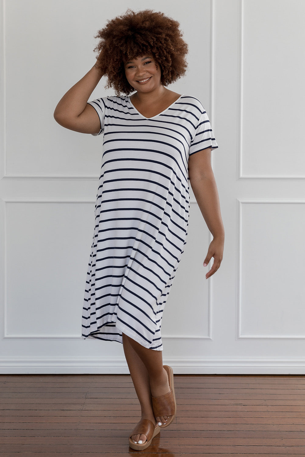 A model wearing the Tin colourShirt Dress - Stripe (White), from the front, showing the whole outfit